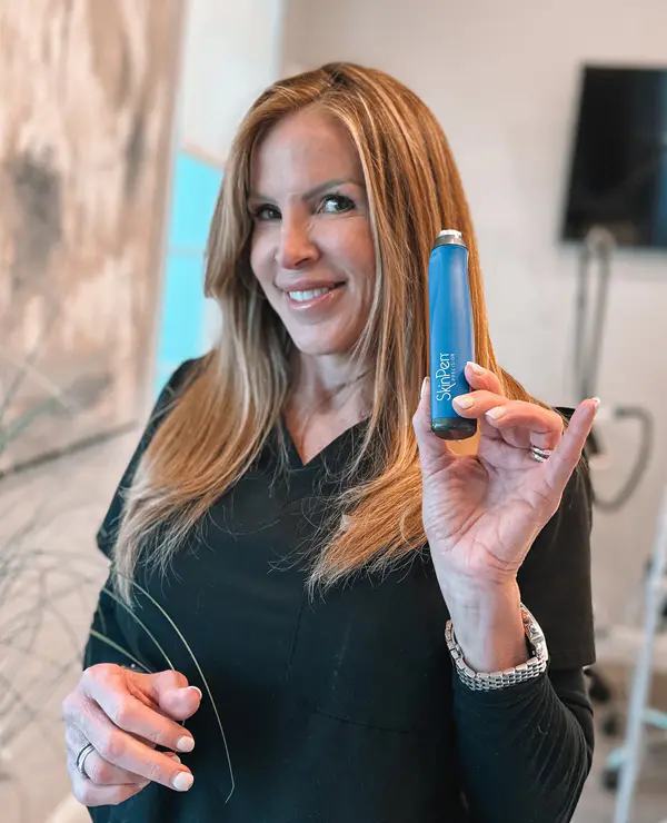 Refresh - Aesthetics & Wellness provider holding a SkinPen microneedling device in a Florida med spa